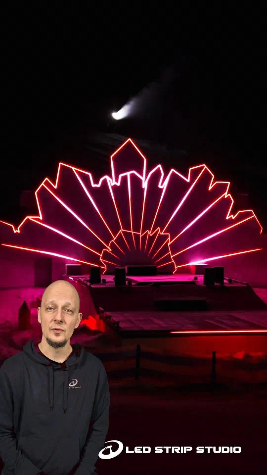 The Pixel stage at Serfaus at night – crystal-shaped panels outlined in glowing red and pink LED lines on the snowy slope, with a presenter in a grey LED Strip Studio hoodie in front – cover picture of the LED Strip Studio Instagram reel