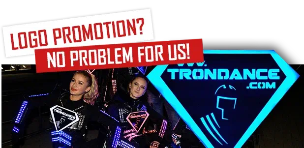 Logo promotion? No problem for us! – two girls in LED suits with glowing logo signs on the chest next to a big glowing blue www.trondance.com logo