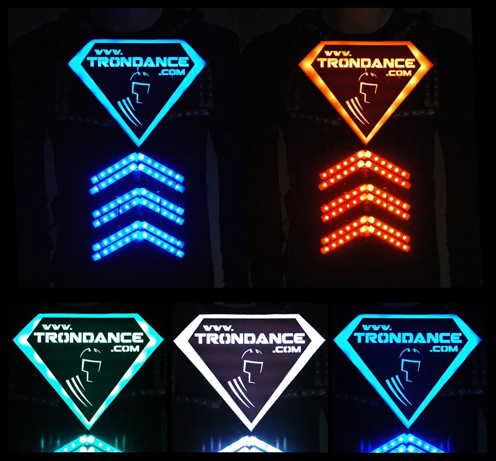 Five photos of the diamond-shaped www.trondance.com logo chest part of an LED suit, glowing in a different colour in each – blue, orange, turquoise, white and light blue – with glowing LED chevrons below it