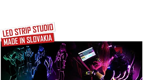 LED Strip Studio – Made in Slovakia – red and white banners above Tron dancers in glowing LED suits and a dancer programming the show on a laptop