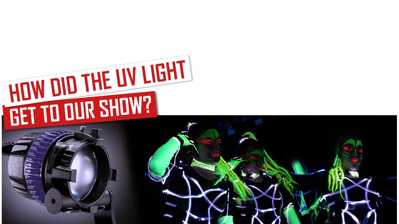 How did the UV light get to our show? – red and white banners above a UV lamp and three Tron Girls with neon green UV make-up and braids, in suits outlined with white fiber optic cable