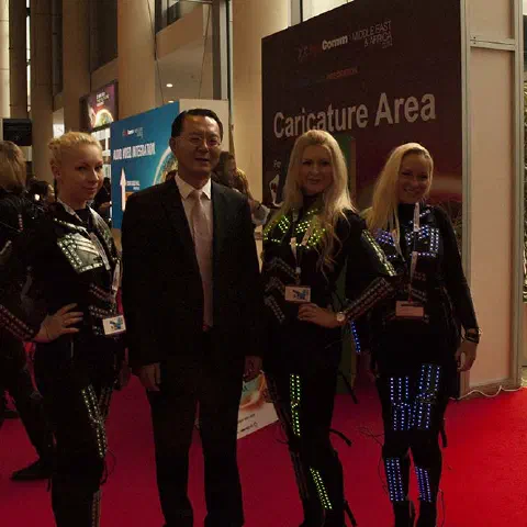 Girls in glowing LED suits handing out invitations and posing for pictures and selfies with visitors at the exhibition in Dubai – photo 3