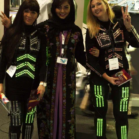 Girls in glowing LED suits handing out invitations and posing for pictures and selfies with visitors at the exhibition in Dubai – photo 4