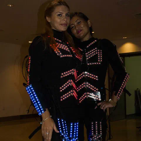 Girls in glowing LED suits handing out invitations and posing for pictures and selfies with visitors at the exhibition in Dubai – photo 9