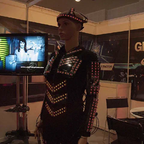 Girls in glowing LED suits handing out invitations and posing for pictures and selfies with visitors at the exhibition in Dubai – photo 10