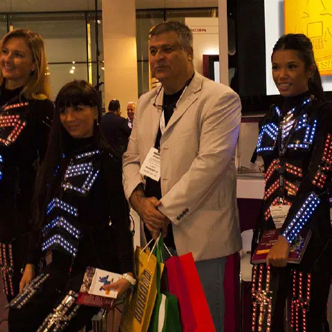Girls in glowing LED suits handing out invitations and posing for pictures and selfies with visitors at the exhibition in Dubai – photo 11