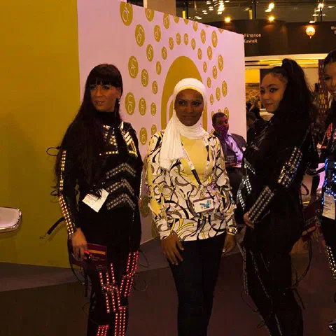 Girls in glowing LED suits handing out invitations and posing for pictures and selfies with visitors at the exhibition in Dubai – photo 12