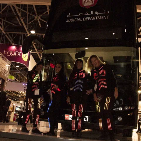 Girls in glowing LED suits handing out invitations and posing for pictures and selfies with visitors at the exhibition in Dubai – photo 13