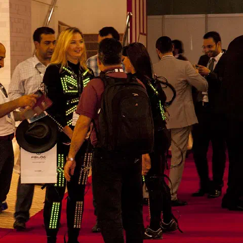 Girls in glowing LED suits handing out invitations and posing for pictures and selfies with visitors at the exhibition in Dubai – photo 14