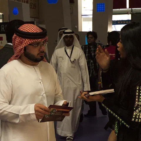 Girls in glowing LED suits handing out invitations and posing for pictures and selfies with visitors at the exhibition in Dubai – photo 15