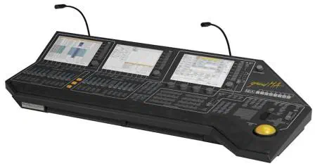 grandMA lighting console with three touch screens, rows of faders and buttons, two gooseneck lamps and a yellow trackball