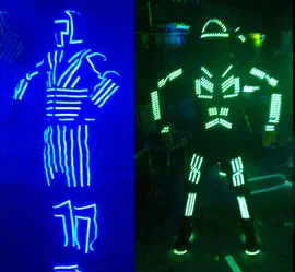 Two LED suits side by side – the old one with dense, continuous blue LED lines and the new one with green LED strip segments showing single LEDs
