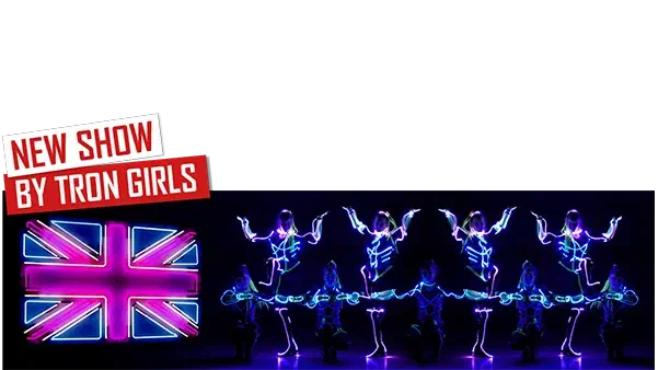 New show by Tron Girls – red and white banners above a neon Union Jack and Tron Girls in glowing blue and pink LED costumes posing in a mirrored line on a dark stage
