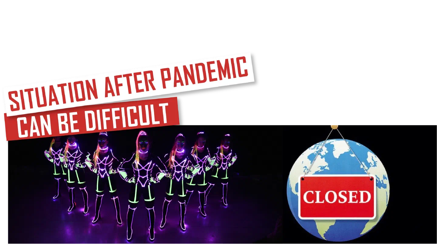 Situation after pandemic can be difficult – red and white banners above seven Tron Girls in black suits glowing with neon green and purple lines on a dark stage, next to a globe hanging on a string with a red Closed sign