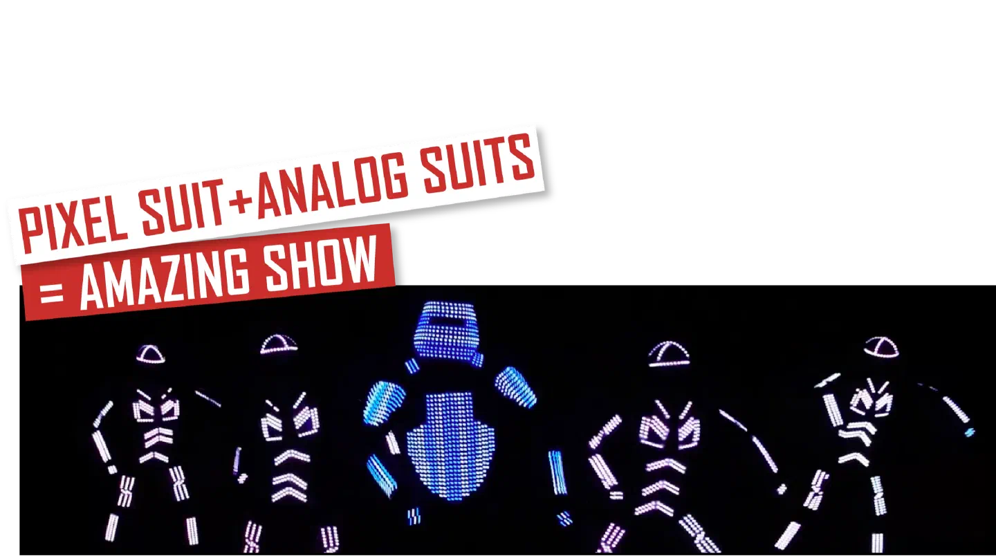 Pixel suit + analog suits = amazing show – red and white banners above five LED dancers in the dark, a pixel suit glowing blue in the middle of four analog suits glowing white and pink