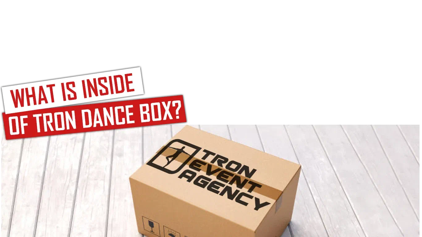 What is inside of Tron Dance box? – red and white banners above a cardboard box with the Tron Event Agency logo on a white wooden floor