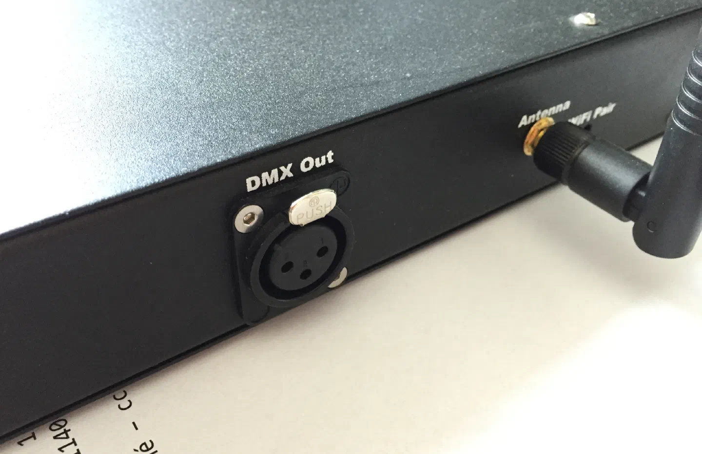 Back of the Tron Dance Ethernet controller – a black metal box with a “DMX Out” XLR socket next to the Wi-Fi antenna