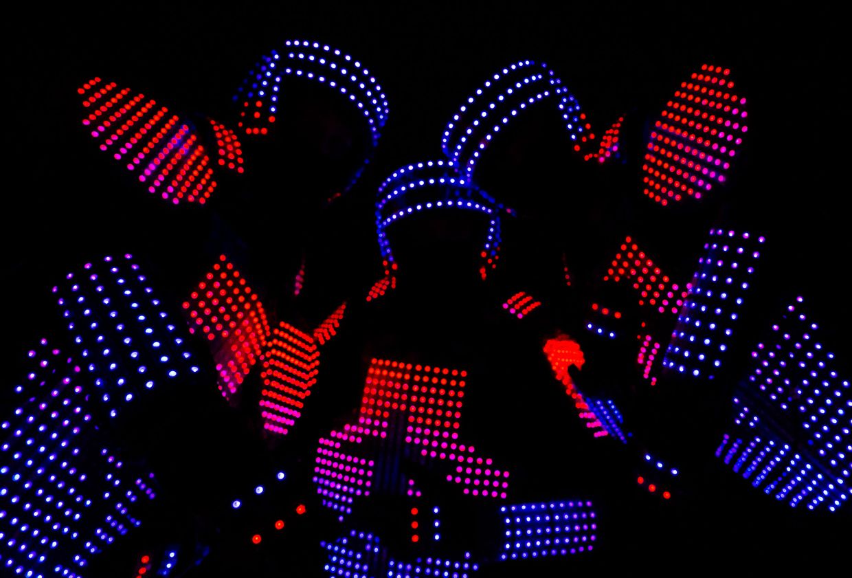 Close-up of Tron Pixel Show dancers in suits covered with blue and red LED pixels