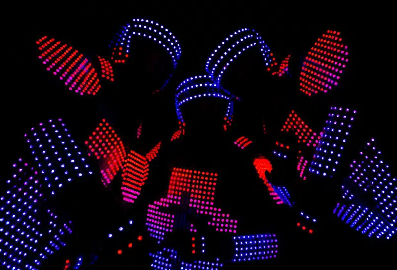 Close-up of Tron Pixel Show dancers in suits covered with blue and red LED pixels