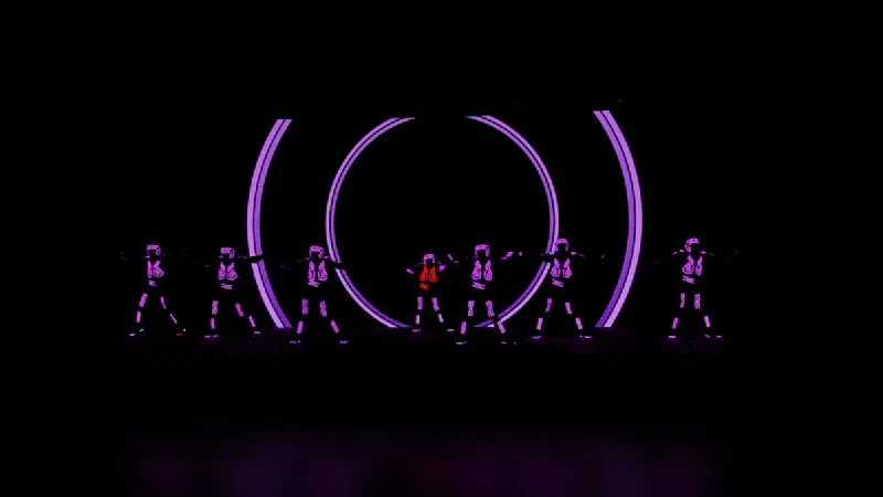 Tron Dance Gen II dancers in front of purple ring visuals on an LED wall