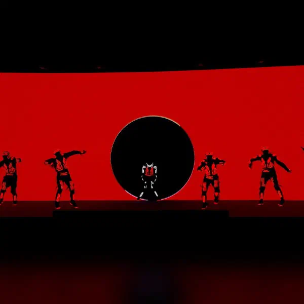 Tron Dance Gen II: seven dancers silhouetted against a red LED screen, one framed by a black circle in the centre
