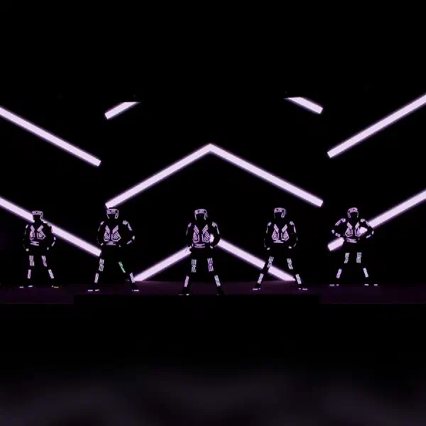 Tron Dance Gen II: seven LED dancers in a line beneath white chevron light patterns in an LED screen dance show