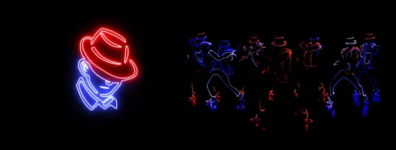 A glowing red and blue outline of a man in a hat next to Tron Man dancers in LED-outlined suits and hats on a dark stage