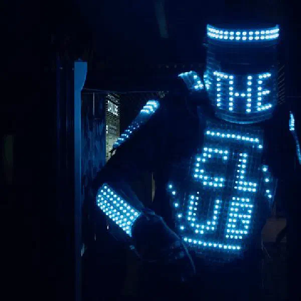 Tron Pixel Robot: LED robot with a blue pixel helmet and chest screen spelling 'THE CLUB' in a dark interior