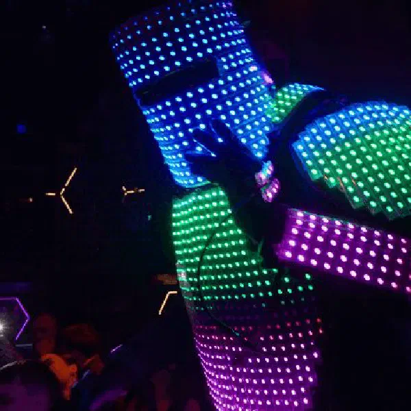 Tron Pixel Robot: robot glowing with blue, green and violet pixel LEDs above a club crowd and hexagon lights